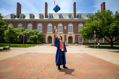 Student tossing graduation cap in the air